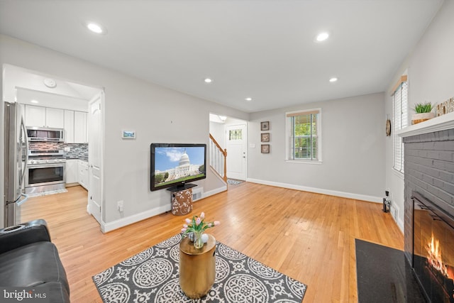 10004 Lorain Ave, Silver Spring, MD 20901 - living area with a brick fireplace, stairs, baseboards, light wood-style flooring, and recessed lighting
