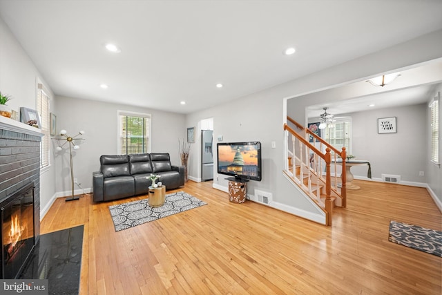 10004 Lorain Ave, Silver Spring, MD 20901 - living area with stairs, a brick fireplace, wood-type flooring, a ceiling fan, and recessed lighting