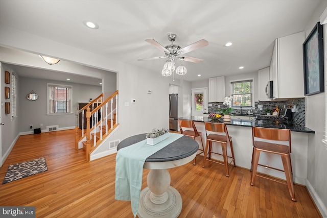 10004 Lorain Ave, Silver Spring, MD 20901 - dining area featuring stairs, light wood finished floors, recessed lighting, a ceiling fan, and baseboards