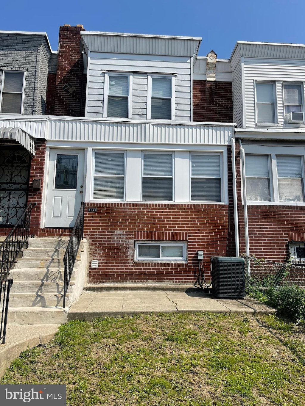 6438 Buist Ave, Philadelphia, PA 19142 - view of front of house featuring central air condition unit, brick siding, and cooling unit