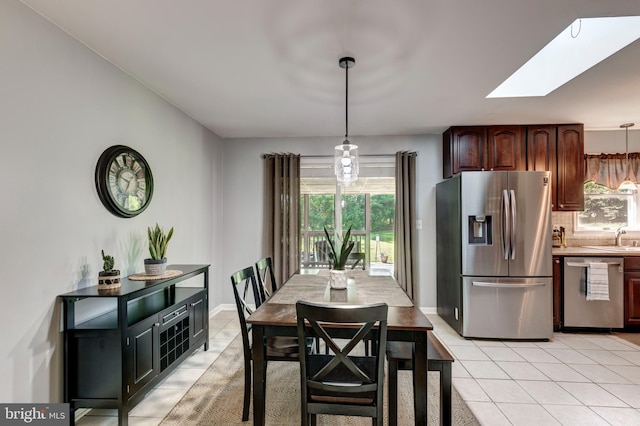 680 Geneva Dr, Westminster, MD 21157 - dining space with light tile patterned flooring, a skylight, healthy amount of natural light, and baseboards