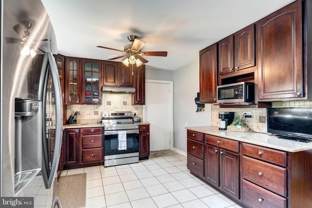 680 Geneva Dr, Westminster, MD 21157 - kitchen featuring appliances with stainless steel finishes, under cabinet range hood, backsplash, ceiling fan, and light tile patterned floors