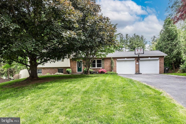 680 Geneva Dr, Westminster, MD 21157 - split level home with a garage, asphalt driveway, a front lawn, and brick siding