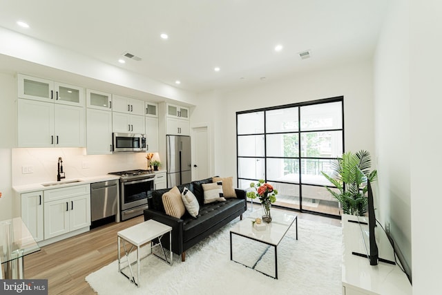 2517 Ontario Rd NW Unit 6, Washington, DC 20009 - living area with light wood-style flooring and recessed lighting