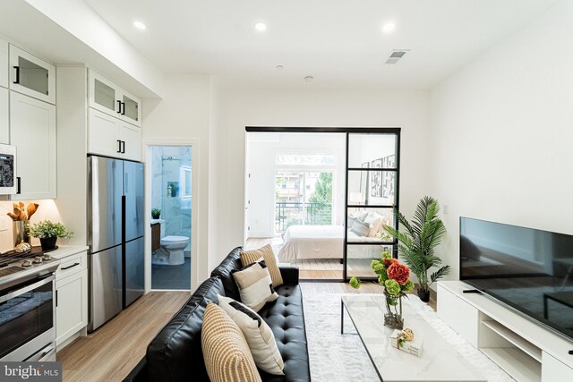 2517 Ontario Rd NW Unit 6, Washington, DC 20009 - living room with light wood finished floors and recessed lighting