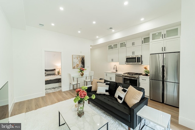 2517 Ontario Rd NW Unit 6, Washington, DC 20009 - living room with light wood-style floors and recessed lighting