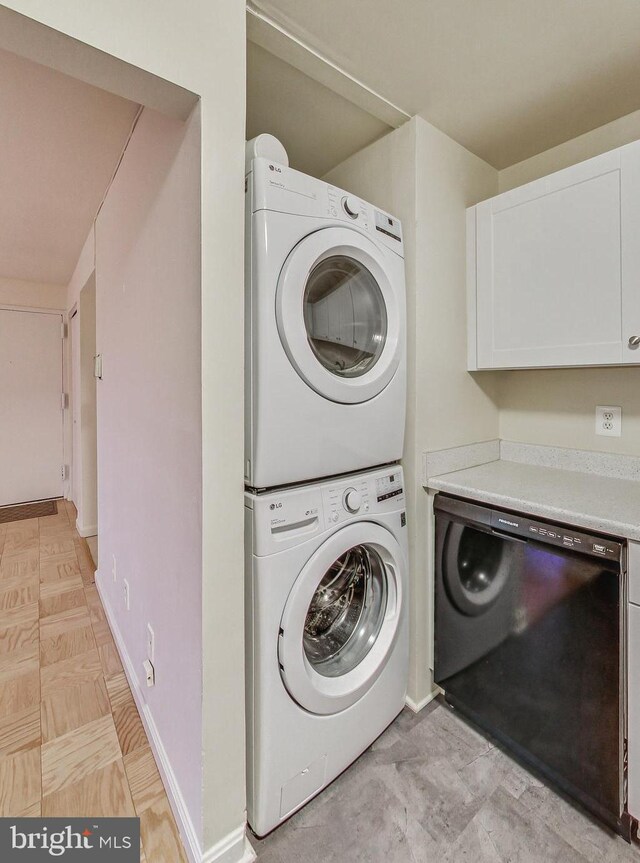 6 Monroe St Unit 6-101, Rockville, MD 20850 - laundry room with stacked washer and clothes dryer and baseboards