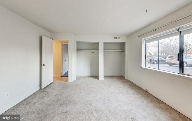 6 Monroe St Unit 6-101, Rockville, MD 20850 - unfurnished bedroom featuring two closets and carpet floors