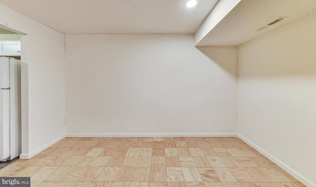 6 Monroe St Unit 6-101, Rockville, MD 20850 - finished below grade area with freestanding refrigerator, tile patterned floors, and recessed lighting