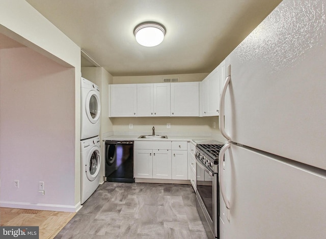 6 Monroe St Unit 6-101, Rockville, MD 20850 - laundry room with stacked washer and clothes dryer and baseboards