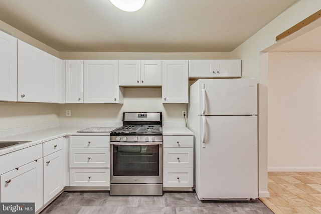 6 Monroe St Unit 6-101, Rockville, MD 20850 - kitchen featuring freestanding refrigerator, stainless steel gas range, white cabinetry, and light countertops