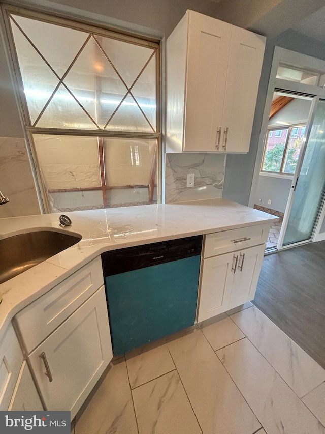 6226 Cardiff St, Philadelphia, PA 19149 - kitchen with dishwashing machine, white cabinets, light marble finish flooring, a sink, and tasteful backsplash