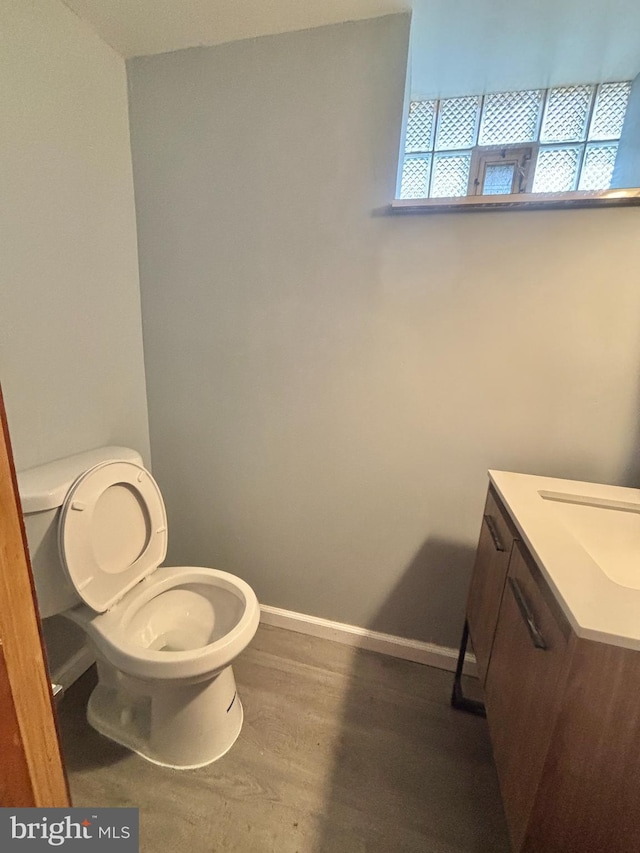6226 Cardiff St, Philadelphia, PA 19149 - bathroom with vanity, toilet, baseboards, and wood finished floors