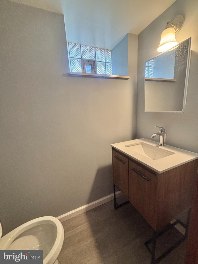 6226 Cardiff St, Philadelphia, PA 19149 - bathroom featuring toilet, vanity, wood finished floors, and plenty of natural light