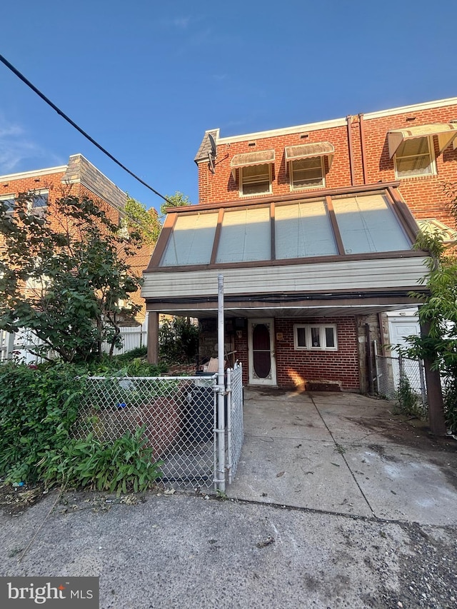 6226 Cardiff St, Philadelphia, PA 19149 - townhome / multi-family property featuring a carport, brick siding, and concrete driveway
