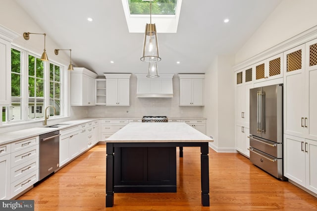 32 Gallup Rd, Princeton, NJ 08540 - kitchen with appliances with stainless steel finishes, a skylight, hanging light fixtures, decorative backsplash, and recessed lighting