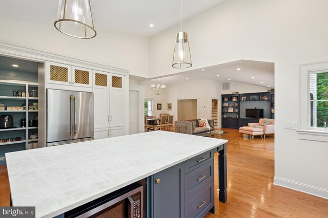 32 Gallup Rd, Princeton, NJ 08540 - kitchen with high end fridge, light countertops, light wood-style floors, white cabinets, and pendant lighting