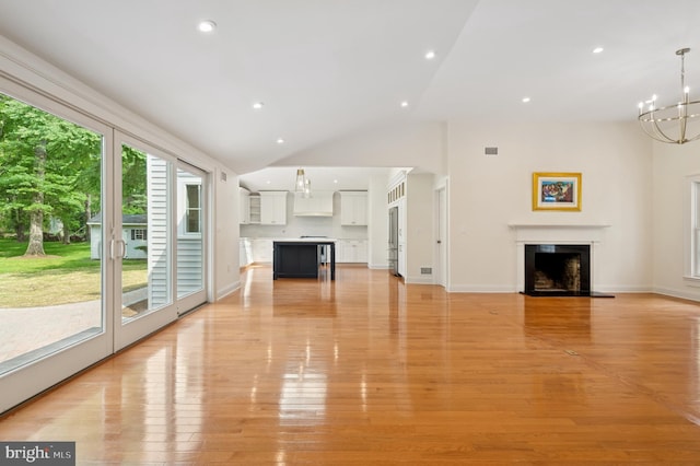 32 Gallup Rd, Princeton, NJ 08540 - unfurnished living room featuring a chandelier, a fireplace with flush hearth, light wood-type flooring, recessed lighting, and high vaulted ceiling