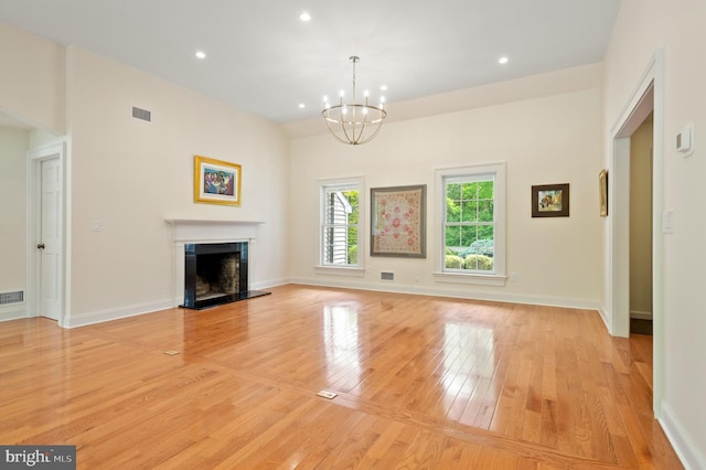 32 Gallup Rd, Princeton, NJ 08540 - unfurnished living room featuring light wood-style flooring, a chandelier, recessed lighting, and a fireplace with raised hearth