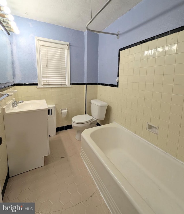 3407 Verner St, Drexel Hill, PA 19026 - full bathroom featuring a tub to relax in, tile patterned floors, tile walls, vanity, and radiator heating unit