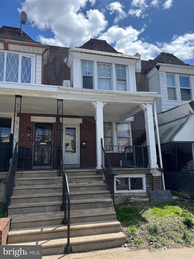 5224 Florence Ave, Philadelphia, PA 19143 - view of property with brick siding, covered porch, and stairs