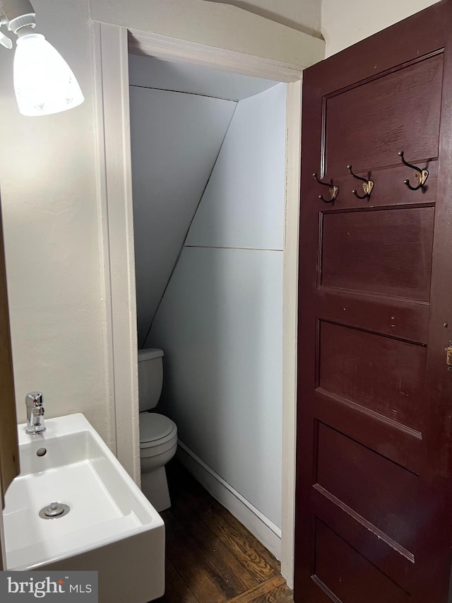 5224 Florence Ave, Philadelphia, PA 19143 - bathroom with toilet, a sink, wood finished floors, and baseboards