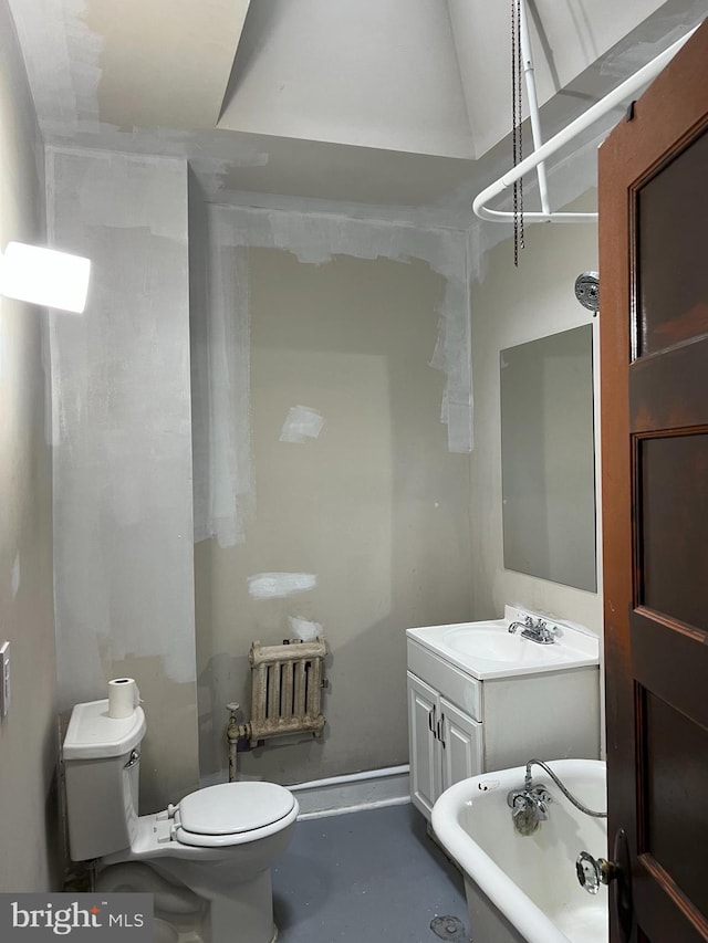 5224 Florence Ave, Philadelphia, PA 19143 - bathroom with toilet, a freestanding bath, vanity, and concrete flooring