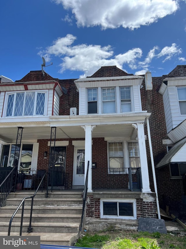 5224 Florence Ave, Philadelphia, PA 19143 - townhome / multi-family property featuring covered porch and brick siding