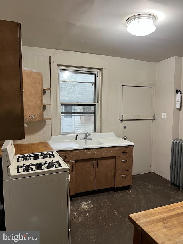 5224 Florence Ave, Philadelphia, PA 19143 - kitchen featuring gas range gas stove, a sink, radiator, concrete flooring, and light countertops