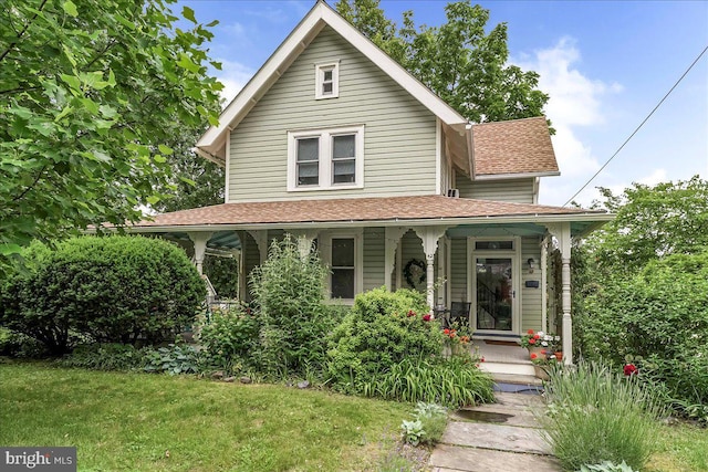 42 Linden Ave, Rutledge, PA 19070 - view of front of home with covered porch, a shingled roof, and a front lawn