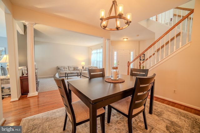 854 Hinchley Run, West Chester, PA 19382 - dining area with ornate columns, light wood-style floors, a chandelier, and stairs