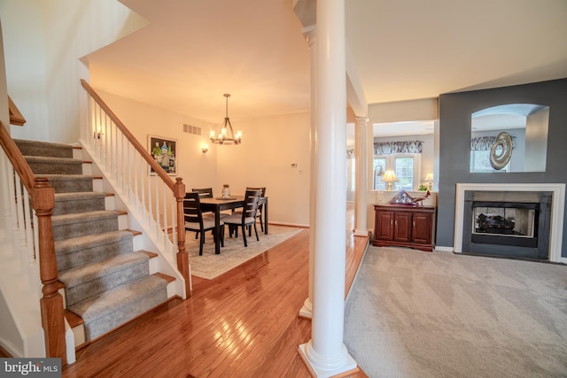 854 Hinchley Run, West Chester, PA 19382 - foyer entrance with stairway, ornate columns, light wood-style floors, a fireplace, and a chandelier