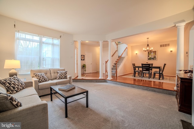854 Hinchley Run, West Chester, PA 19382 - carpeted living room featuring ornate columns, stairway, and a chandelier