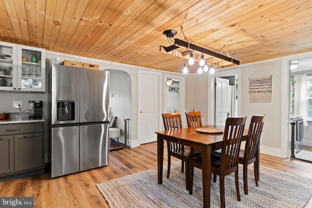 3645 N Susquehanna Trl, York, PA 17404 - dining room featuring wooden ceiling, light wood finished floors, arched walkways, a chandelier, and baseboards