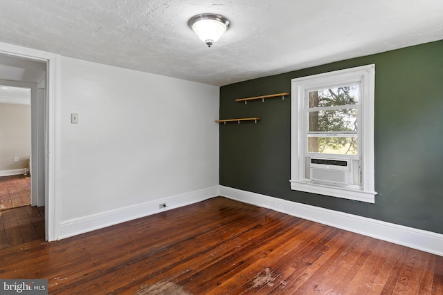 3645 N Susquehanna Trl, York, PA 17404 - spare room with wood-type flooring, baseboards, and cooling unit