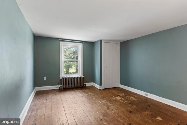 3645 N Susquehanna Trl, York, PA 17404 - spare room featuring radiator heating unit, hardwood / wood-style flooring, and baseboards