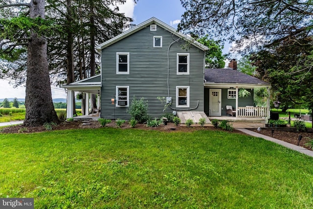 3645 N Susquehanna Trl, York, PA 17404 - view of front of home with covered porch, a front lawn, and a chimney