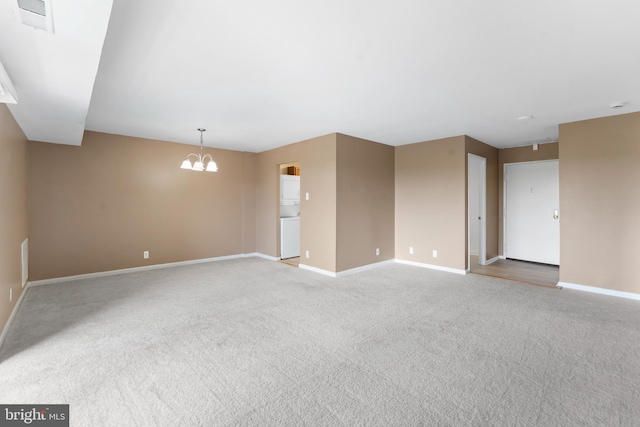 12001 Old Columbia Pike Unit 709, Silver Spring, MD 20904 - spare room featuring a chandelier, baseboards, and carpet