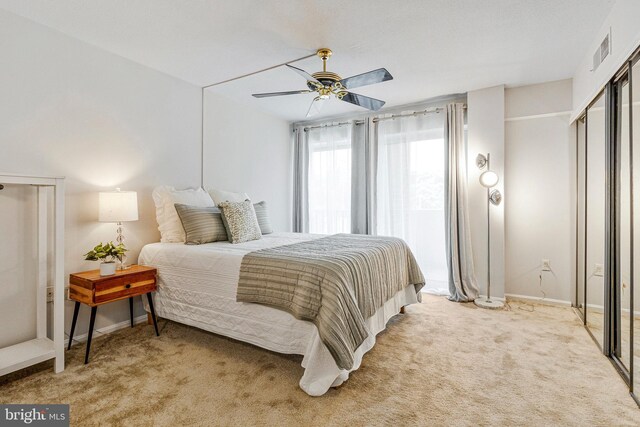 1300 Army Navy Dr S Unit 227, Arlington, VA 22202 - bedroom with light colored carpet, a ceiling fan, and a closet