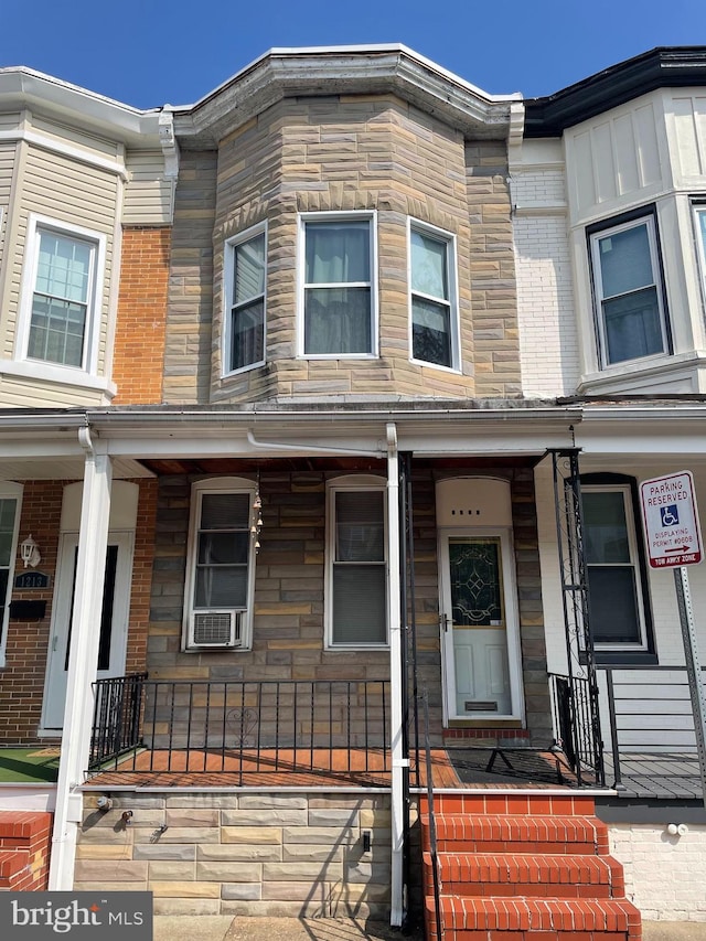 1215 Cleveland St, Baltimore, MD 21230 - townhome / multi-family property with a porch and stone siding