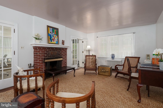 1 Kensington Ave, Trenton, NJ 08618 - carpeted living room featuring radiator heating unit and a brick fireplace