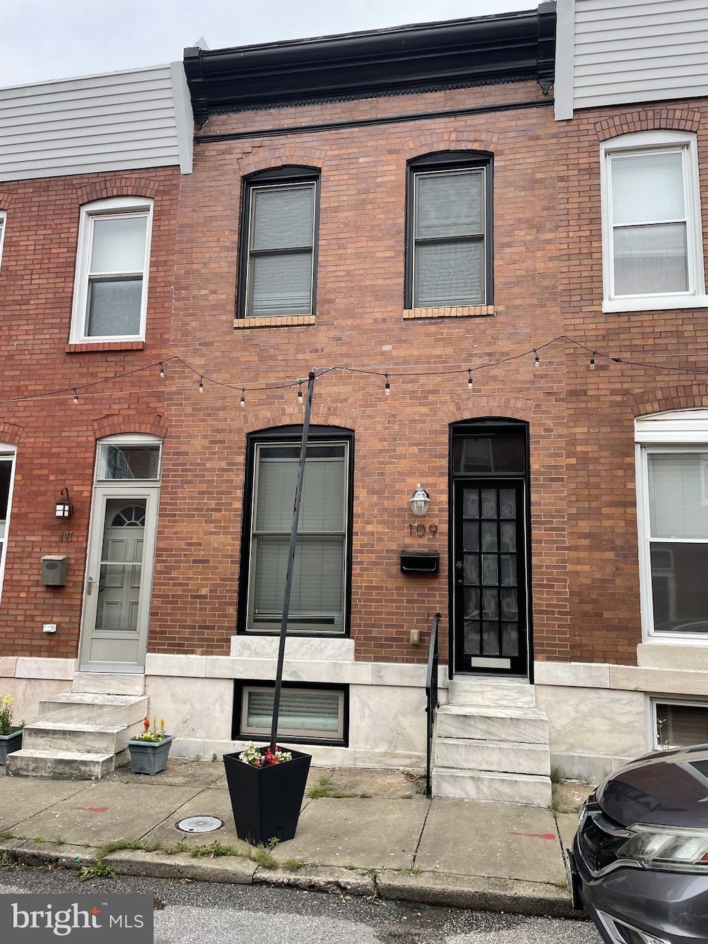 109 Curley St, Baltimore, MD 21224 - townhome / multi-family property with entry steps and brick siding