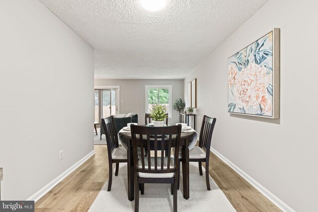 2825 Cambridge Dr, Woodbridge, VA 22192 - dining room with a textured ceiling and light wood-type flooring
