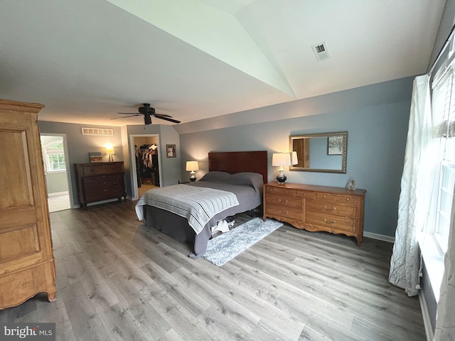 25 Baldwin Cir, Glenmoore, PA 19343 - bedroom with light wood-style flooring, a walk in closet, a closet, and vaulted ceiling