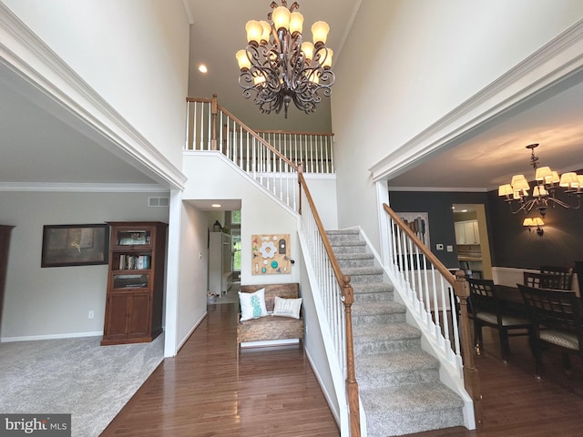 25 Baldwin Cir, Glenmoore, PA 19343 - staircase featuring a chandelier, a towering ceiling, wood finished floors, and ornamental molding
