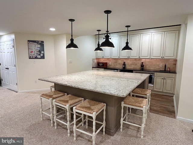 25 Baldwin Cir, Glenmoore, PA 19343 - kitchen with a kitchen breakfast bar, carpet, backsplash, a kitchen island, and recessed lighting