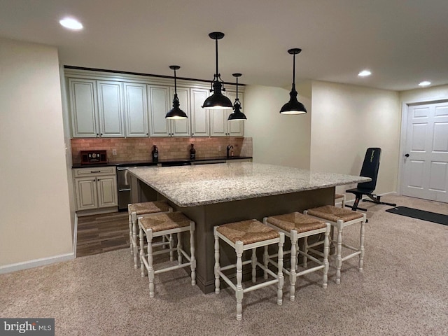25 Baldwin Cir, Glenmoore, PA 19343 - kitchen with carpet flooring, a breakfast bar area, a kitchen island, tasteful backsplash, and dishwasher