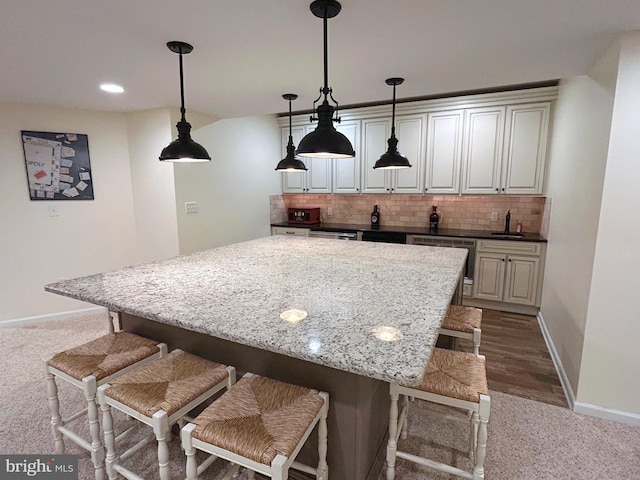 25 Baldwin Cir, Glenmoore, PA 19343 - kitchen featuring stainless steel dishwasher, dark carpet, a kitchen breakfast bar, decorative backsplash, and a kitchen island