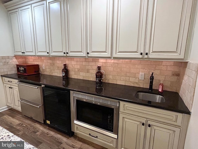 25 Baldwin Cir, Glenmoore, PA 19343 - kitchen with stainless steel microwave, decorative backsplash, dark wood-style floors, dishwasher, and dark stone counters