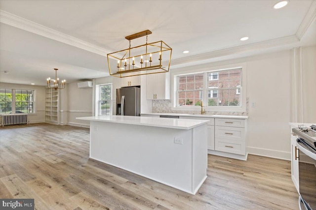 464 Fairfield Rd, Plymouth Meeting, PA 19462 - kitchen with a chandelier, appliances with stainless steel finishes, radiator heating unit, crown molding, and an AC wall unit